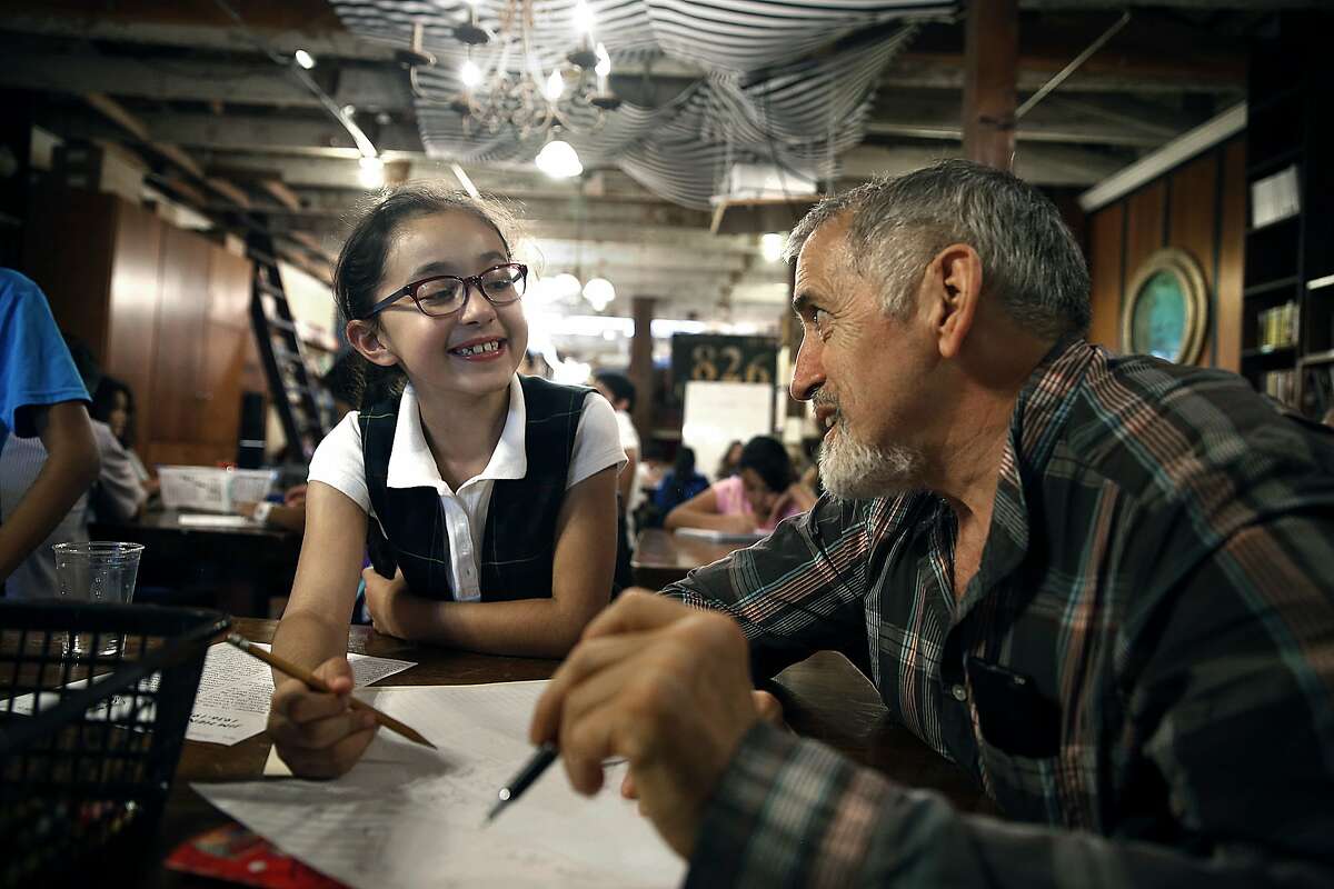 Brenda Hernandez (left), 7 years old, gets help from tutor Clint Seiter (right) in the creative-writing tutoring program at 826 Valencia St. in San Francisco, Calif., on Thursday, September 24, 2015.