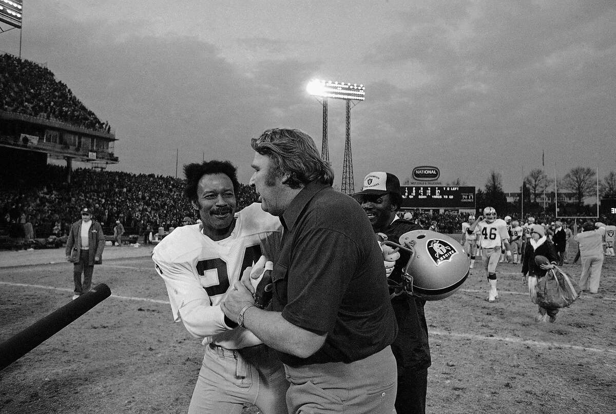 Oakland Raider head coach John Madden is congratulated by defensive back Willie Brown following their team's 37-31 playoff win over the Baltimore Colts on Saturday, Dec. 26, 1977 in Baltimore, Maryland. The game ended in the sixth quarter on a touchdown pass to tight end Dave Casper. (AP Photo)