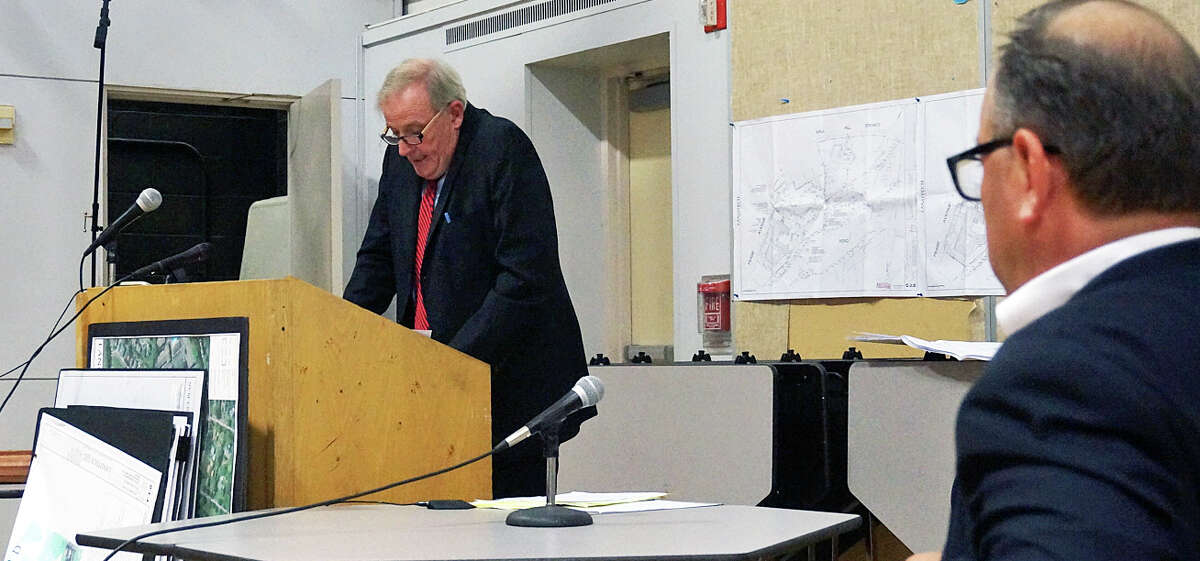John Fallon, attorney for a senior housing project proposed for Mill Hill Terrace, addresses the Inland Wetlands Commission Thursday, while David Rosenstein, an Acorn Lane resident and intervenor in the permit application, listens.