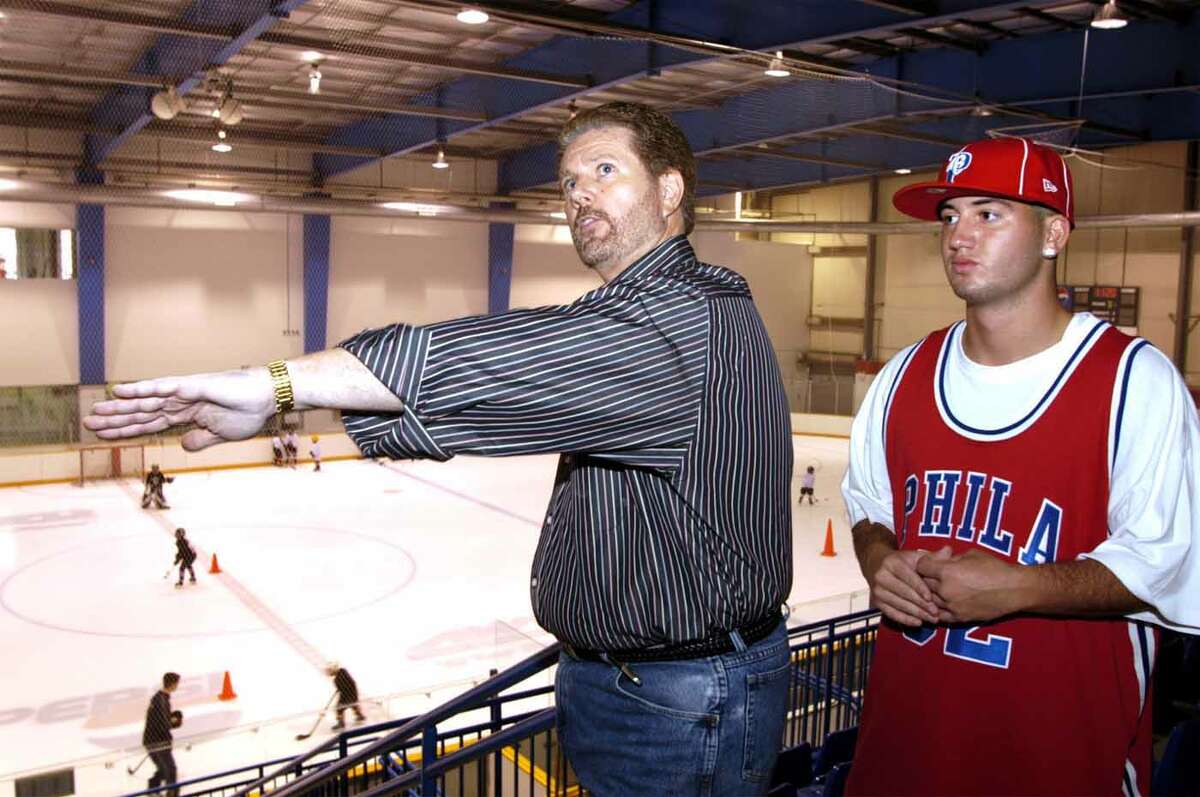 From left, Jim Galante and his son AJ, talk about renovations, which are currently happening to the Danbury Ice Rink. Jim, who is the General Contractor stated, "there wont be a bad seat in the house," August 13,2004 Photo By Chris Ware
