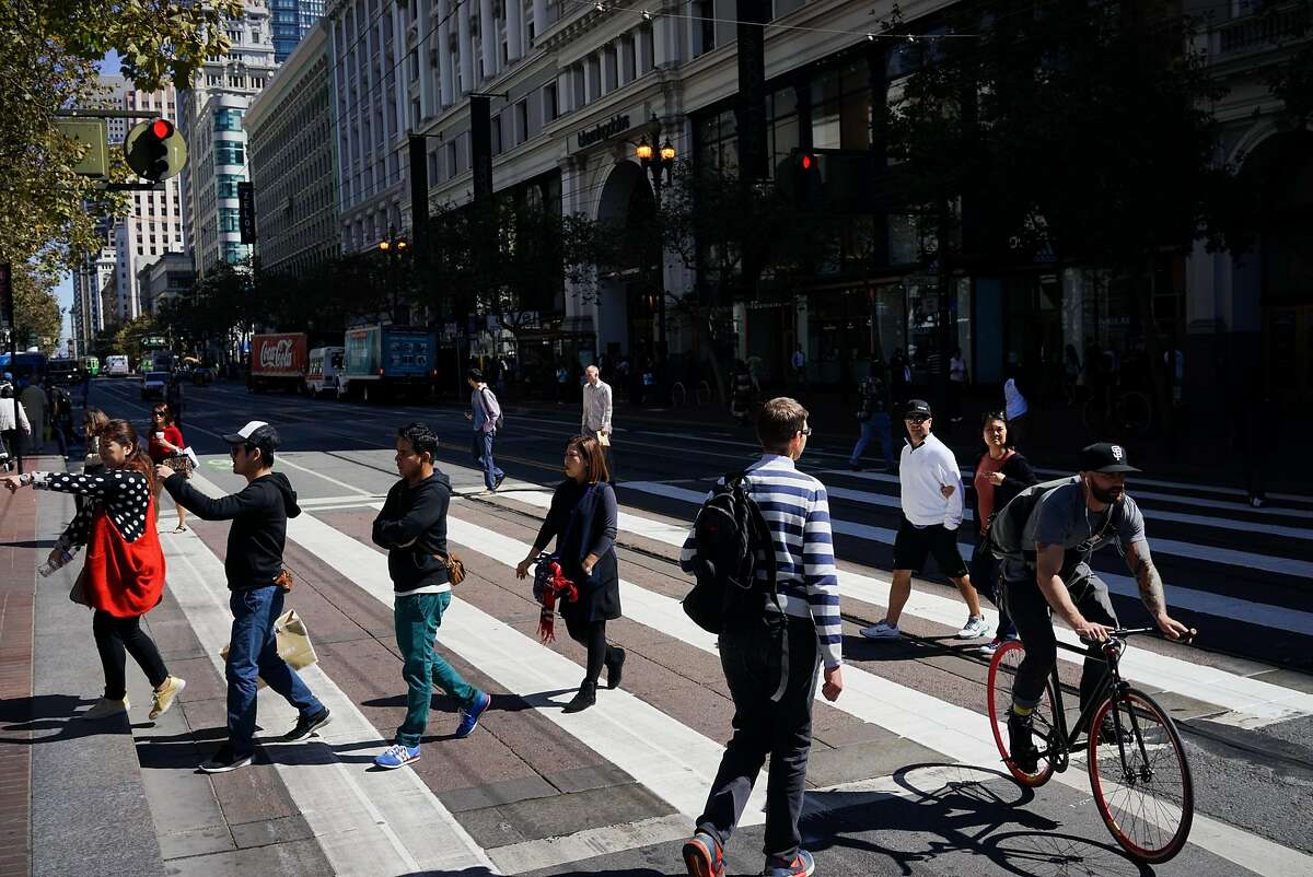 A cyclists rides down Market Street in San Francisco, Calif. on Friday, Sept. 25, 2015. Mayor Ed Lee said he will veto legislation that would require police to make cyclists who don't stop at stop signs a low priority.