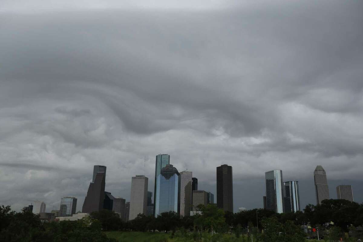 Storm clouds form around the downtown skyline in Houston. ( Steve Gonzales / Houston Chronicle )