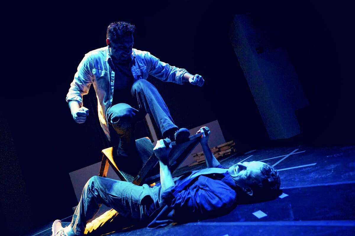 Christopher White (lying down) and Joe Estlack play two survivors in a battle for turf after a disaster in Mugwumpin's "Blockbuster Season" at Intersection