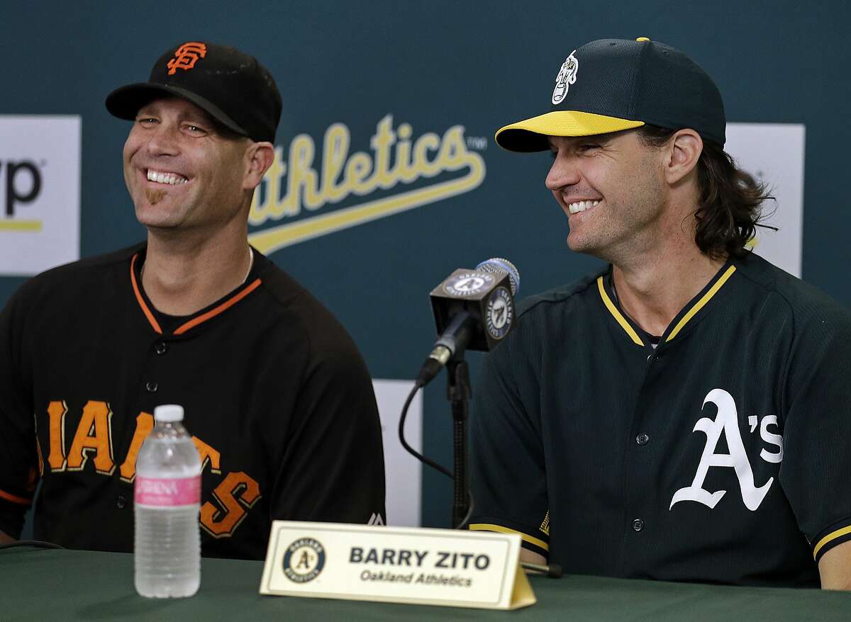 San Francisco Giants pitcher Tim Hudson, left, and Oakland Athletics pitcher Barry Zito smile during a news conference prior to a baseball game Friday, Sept. 25, 2015, in Oakland, Calif. 