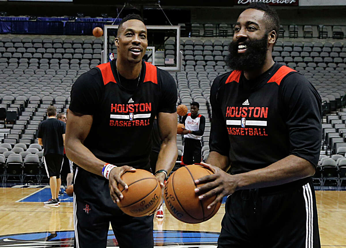 Center Dwight Howard, left, who battled fluid buildup in his knee last season but will be ready for training camp when it begins Tuesday, and guard James Harden remain the cornerstones of the Rockets.