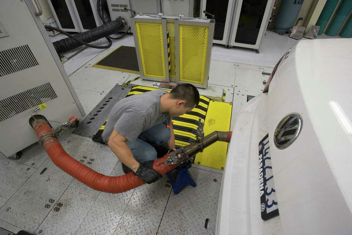 A state technician prepares to test the diesel emissions of a 2013 Volkswagen Passat in El Monte, Calif. The emission tests cheating scandal has shaken not just Volkswagen, but the worldwide auto industry, which is bracing for questions about cheating to sidestep regulations.