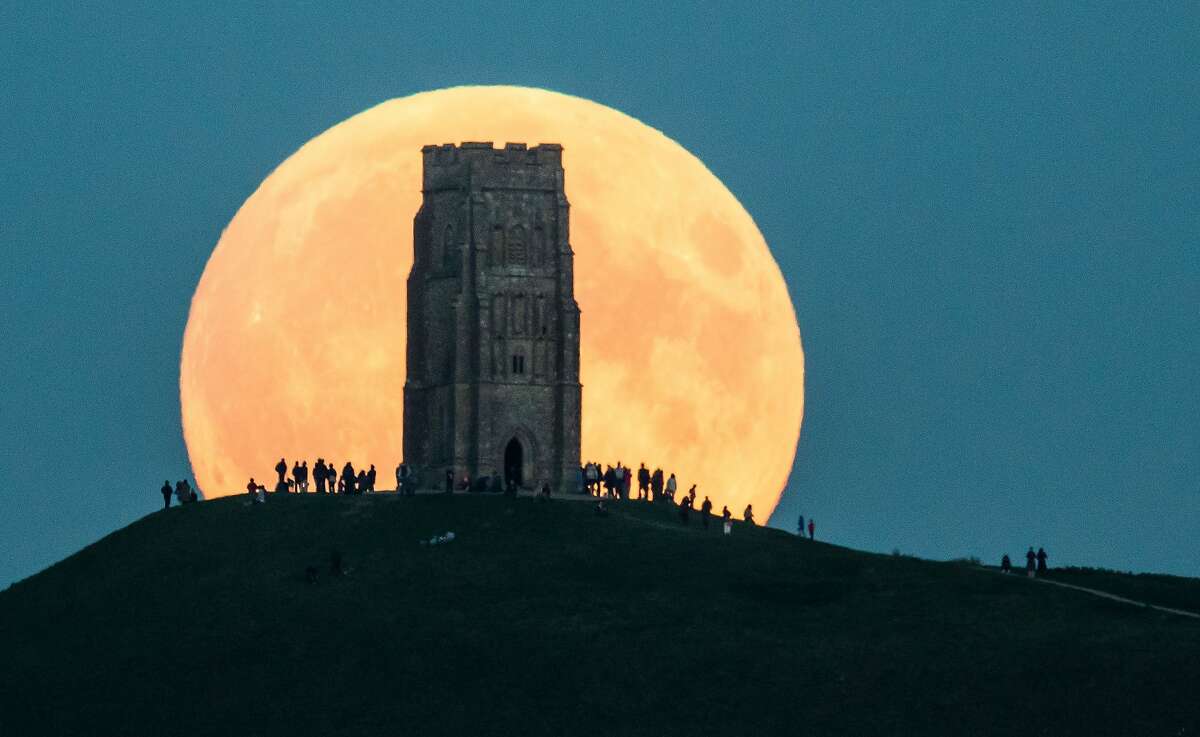 The supermoon rises behind Glastonbury Tor on September 27, 2015 in Glastonbury, England. Tonight's supermoon, so called because it is the closet full moon to the Earth this year, is particularly rare as it coincides with a lunar eclipse, a combination that has not happened since 1982 and won't happen again until 2033. 