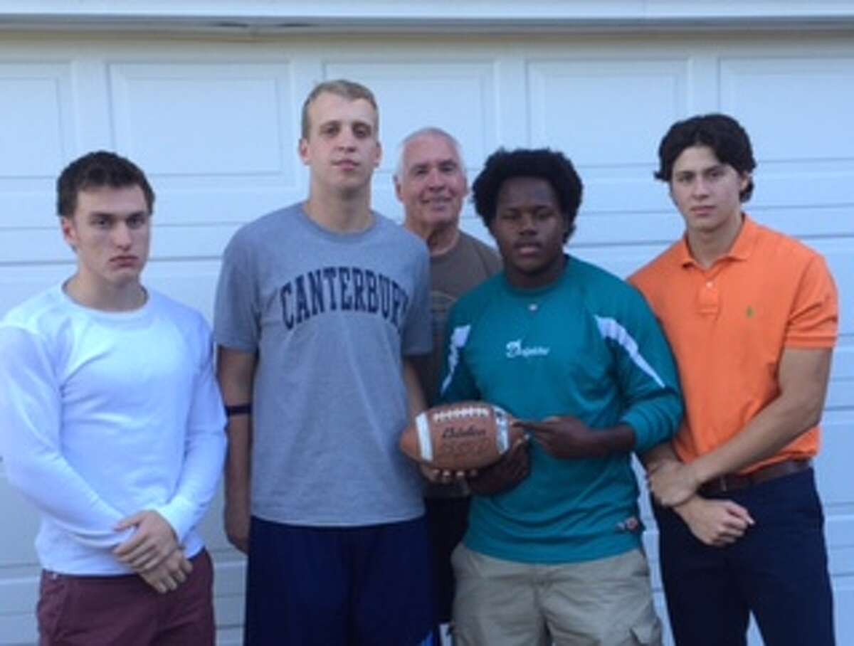 New Canterbury football coach Tom Taylor, back center, with players, from left, Seamus Oeser, Ryan Johannes, Isaiah D'Haiti and Dan Romanello.