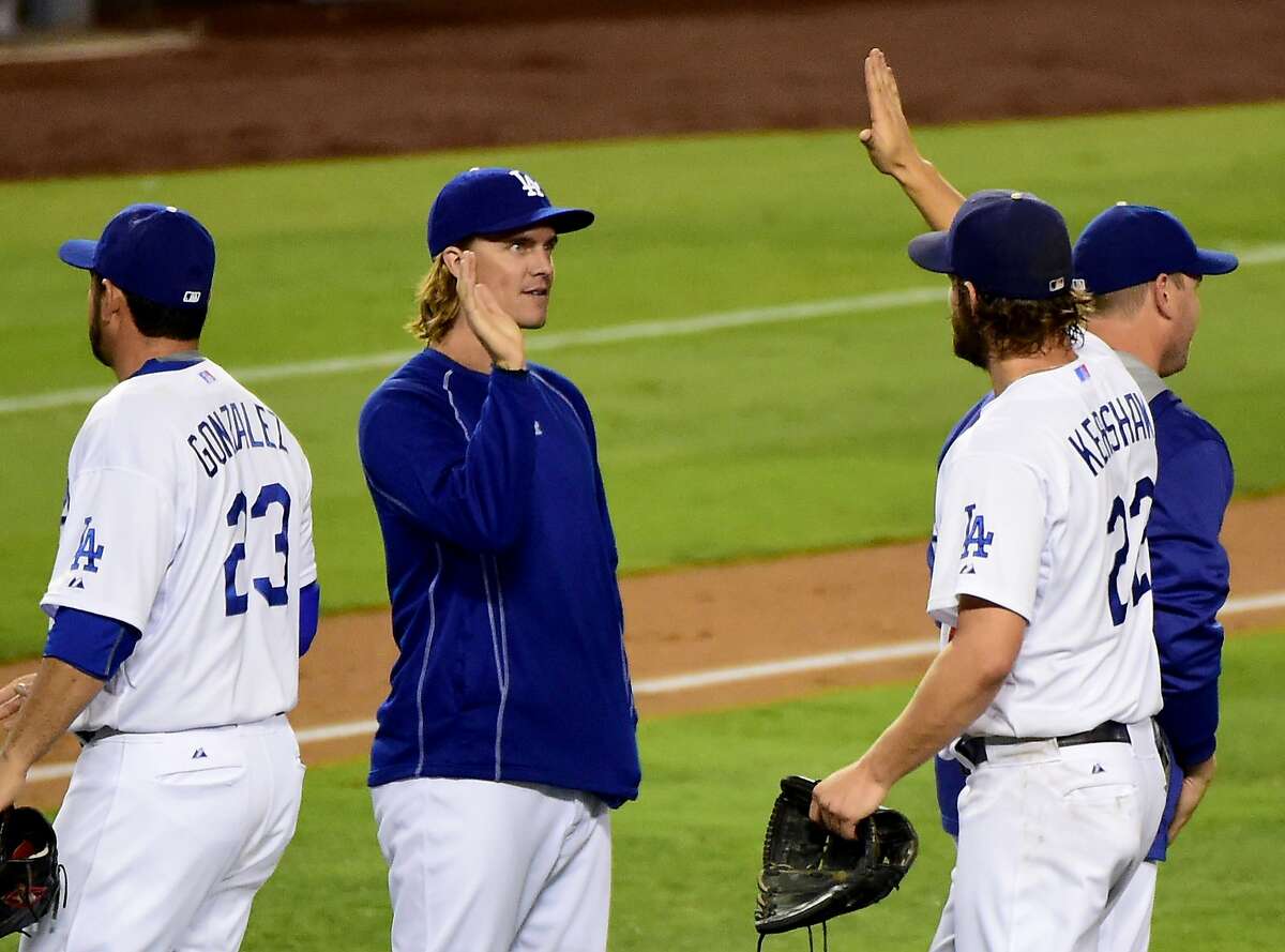 LOS ANGELES, CA - SEPTEMBER 02: Zack Greinke #21 of the Los Angeles Dodgers celebrates a 2-1 complete game win by Clayton Kershaw #22 over the San Francisco Giants at Dodger Stadium on September 2, 2015 in Los Angeles, California. (Photo by Harry How/Getty Images)
