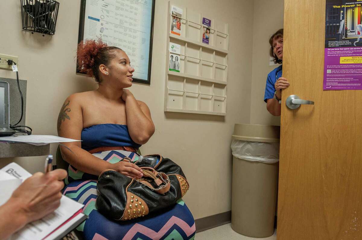 This file photo shows a health care assistant consulting with a patient at the Planned Parenthood Health Center in Akron, Ohio. Planned Parenthood provides much needed health care for women nationwide.