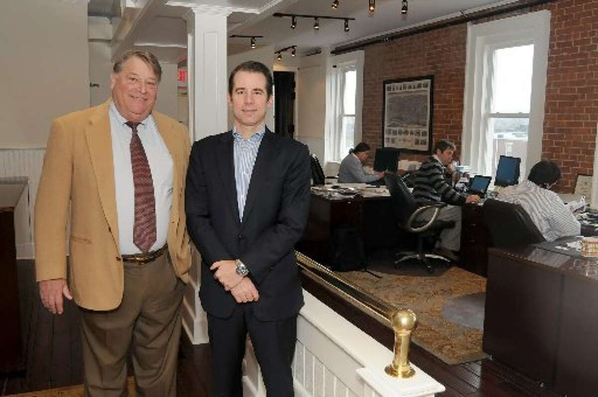 Jim Kick, left, is shown here with GoodWorks chairman Chad Yonker. GoodWorks donates at least half of its annual operating profits to local charities, in addition to providing insurance services to clients