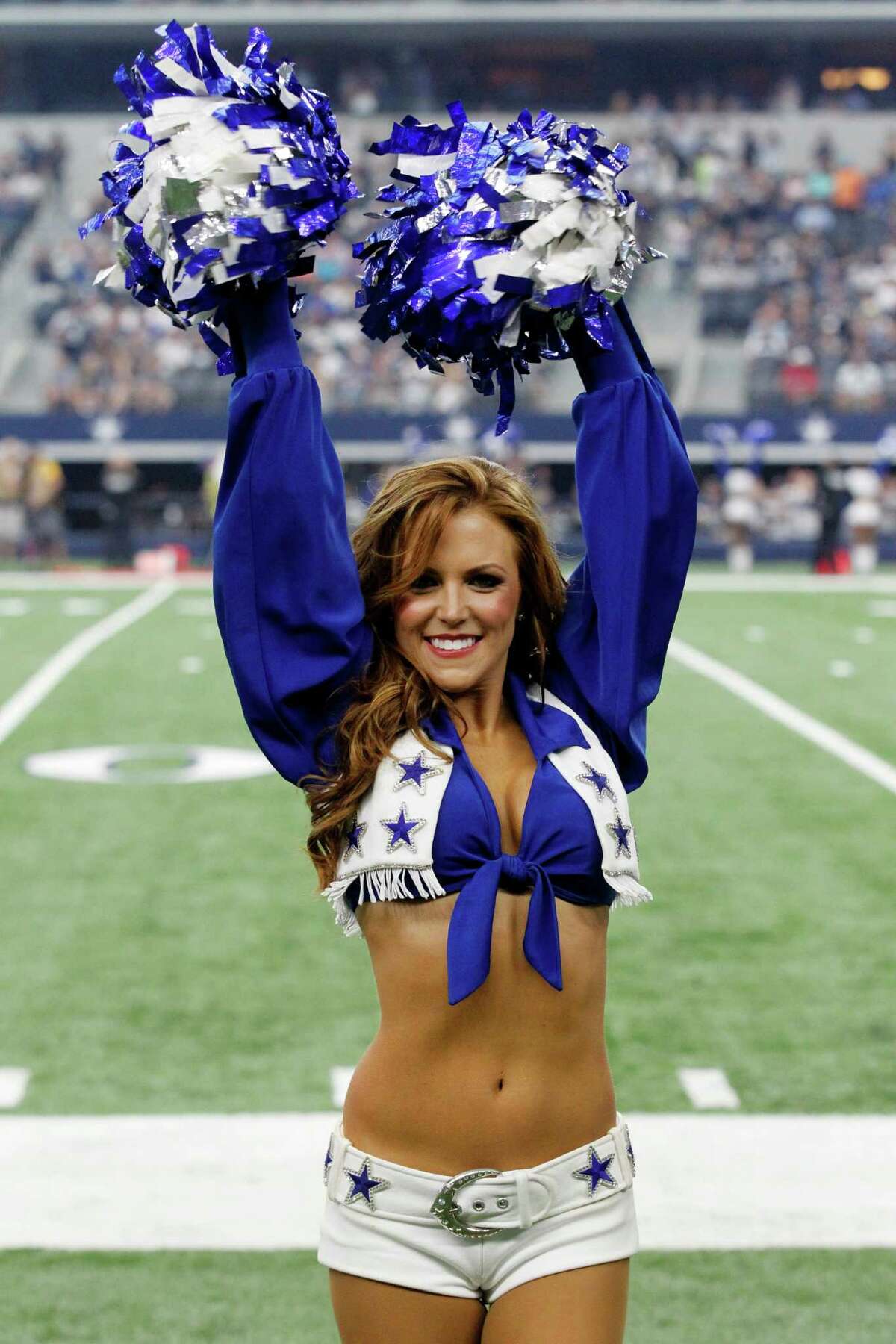 A member of the Dallas Cowboys cheerleaders performs during an NFL football...