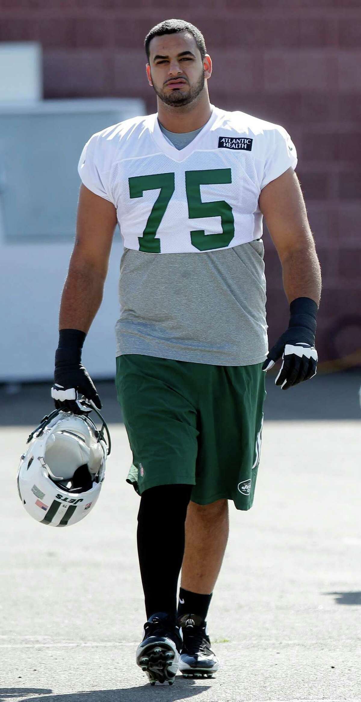 In this Thursday, July 24, 2014 file photo, New York Jets offensive tackle Oday Aboushi (75) walks to practice at Jets NFL football training camp in Cortland, N.Y. Aboushi was part of a five-day surgical mission by the Islamic Medical Association of North America in early March to repair cleft lips Sudan. (AP Photo)