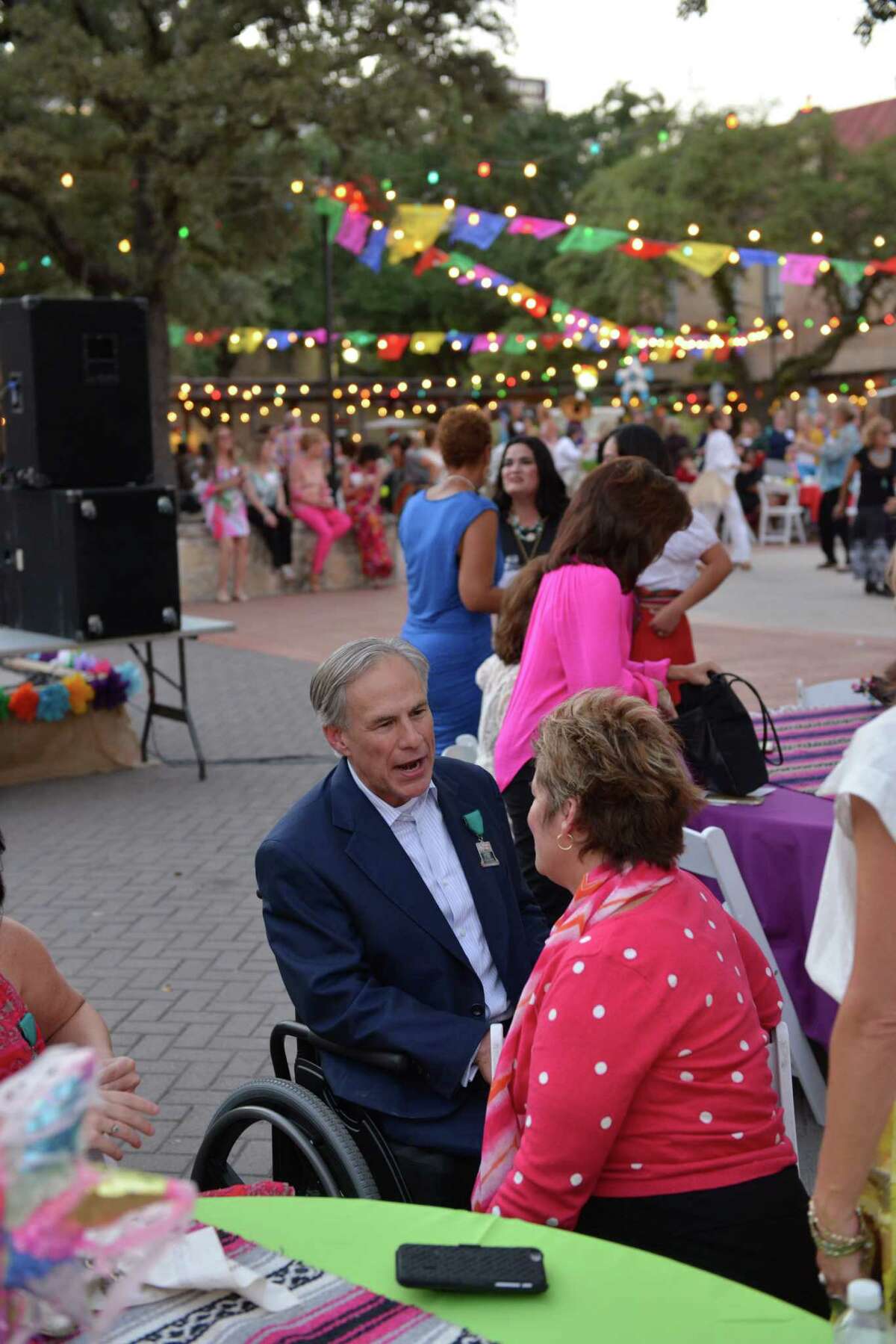 Gov. Greg Abbott speaks to members of the National Association of Women Business Owners at a Monday evening reception event at Maverick Plaza