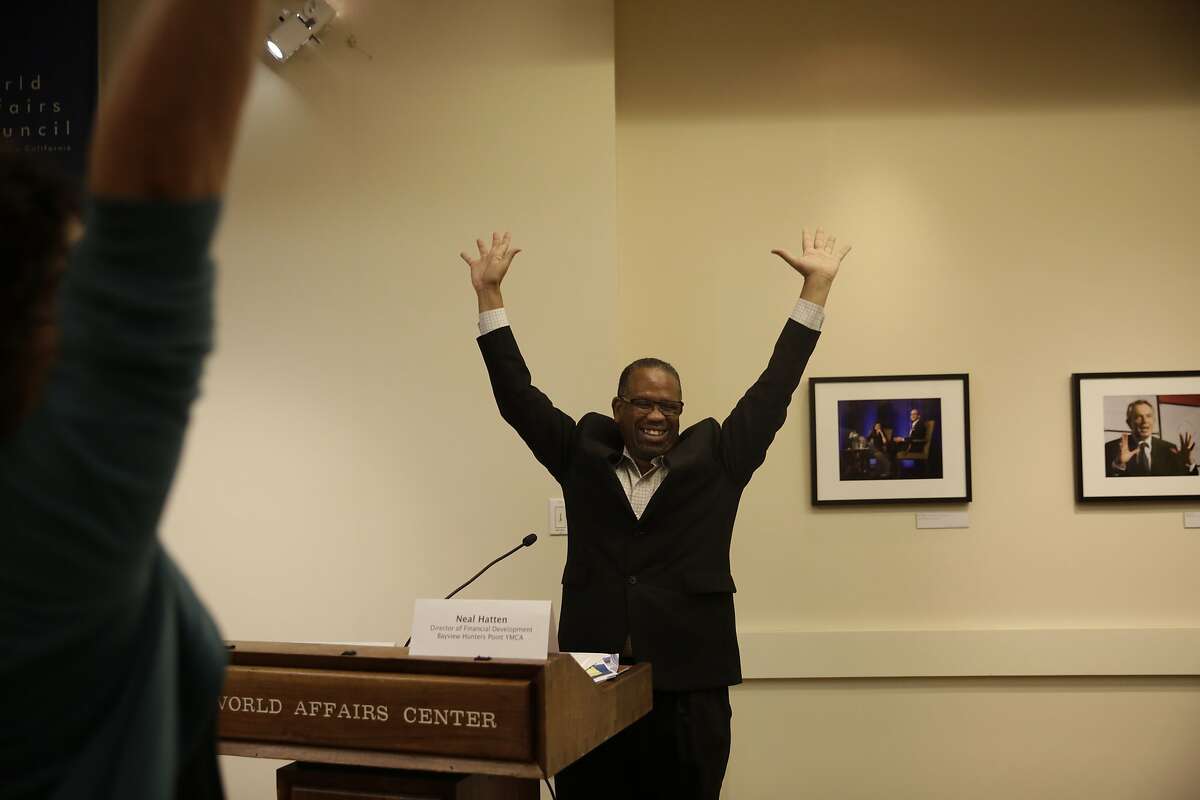 Neal Hatten , director of Financial Development for Bayview Hunters Point YMCA, encourages attendees to stretch as he raises his arms in the air during a news briefing for the Healthy Hearts SF program at the World Affairs Council on Tuesday, September 29, 2015 in San Francisco, Calif.