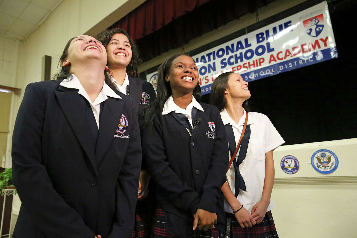 Students Azeal Garza (from left) Meg Garcia Karease Williams and Mallory Sanchez enjoy the glory as Principal Delia McLerran announces to the student body assembled on September 29, 2015 at the SAISD's Young Women's Leadership Academy, that the school has been recognized as a 2015 National Blue Ribbon School on September 29, 2015.