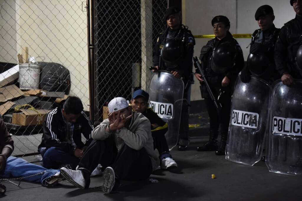 Members of the "Mara Salvatrucha" gang gesture in court in Guatemala City on July 28, 2015. Photo: JOHAN ORDONEZ, AFP/Getty Images