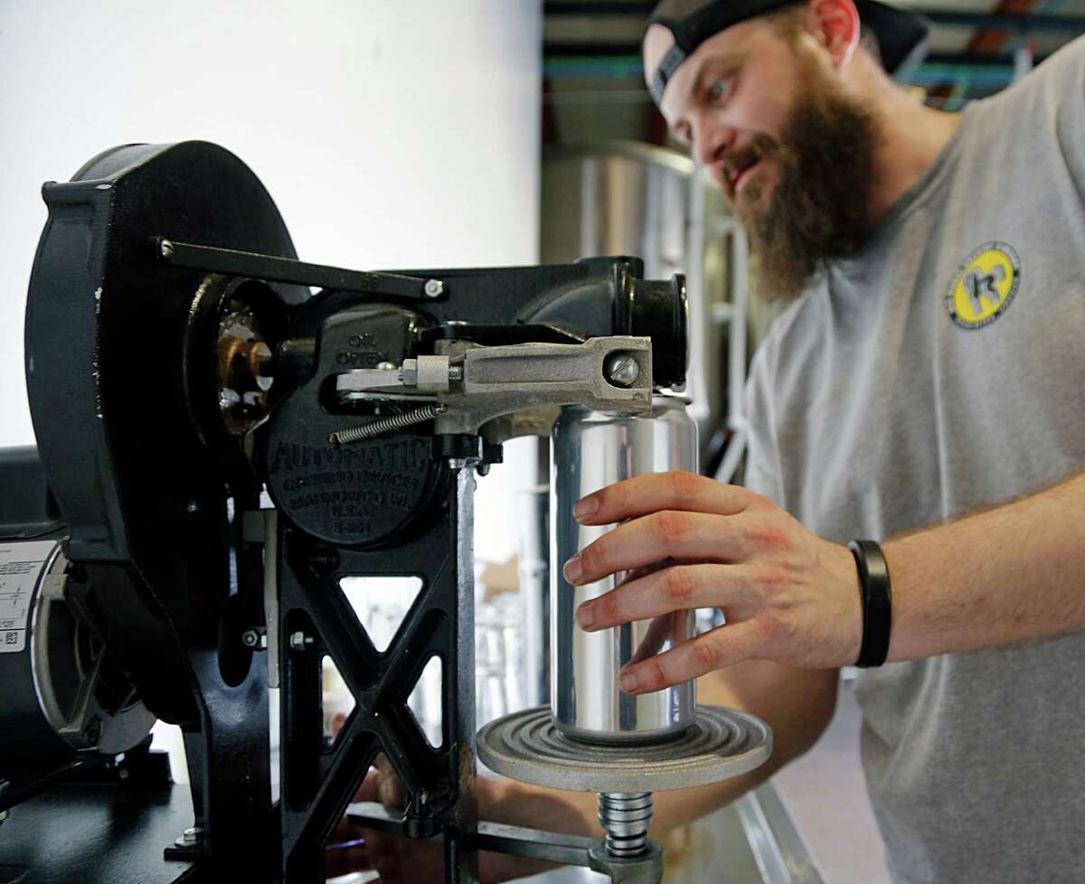 Robbie Cummings with Brash Brewing demonstrates a crowlers machine Tuesday, Sept. 29, 2015, in Houston. ( James Nielsen / Houston Chronicle )