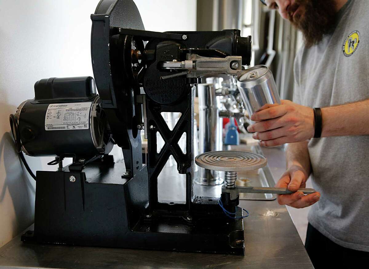 Robbie Cummings with Brash Brewing demonstrates a crowlers machine Tuesday, Sept. 29, 2015, in Houston. ( James Nielsen / Houston Chronicle )