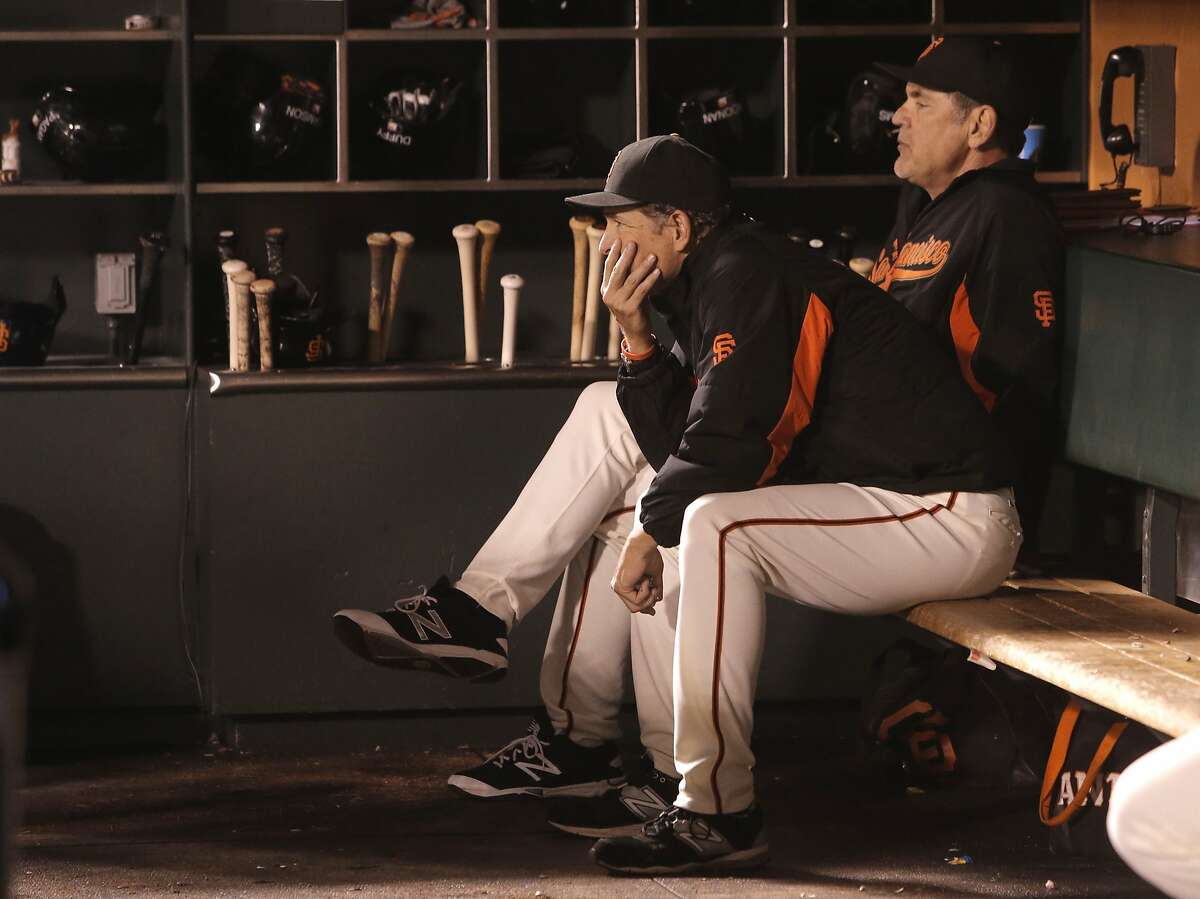 Pitching coach Dave Reghetti, (left) and Manager Bruce Bochy watch from the dugout as the Los Angeles Dodgers went on to beat the San Francisco Giants 8-0 at AT&T Park in San Francisco, Calif., on Tues. September 29, 2015.