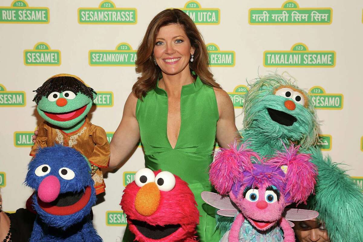 It's Norah O'Donnell, who is seen here posing with Sesame Street Muppets.