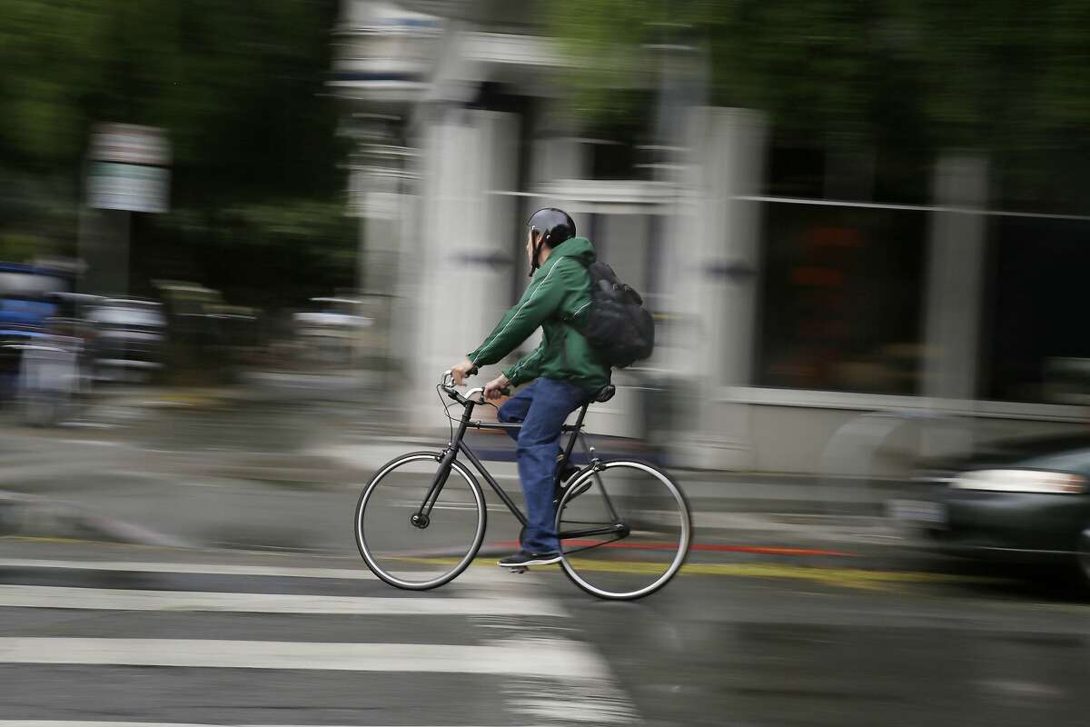 A bicyclist rides through a cross walk while riding along "the wiggle" on Wednesday, September 30, 2015 in San Francisco, Calif. The wiggle is a zigzag route between Market Street and Golden Gate Park which passes through the Lower Haight.