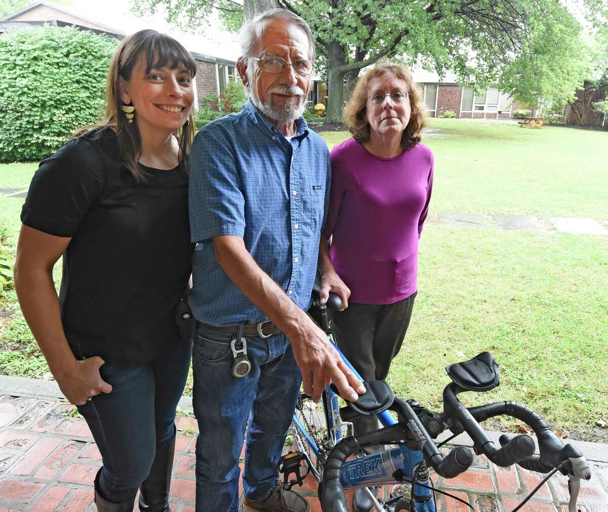 The Strope family, Sara, left, Harold and Miriam stand near Harold's bike at the Albany Academy for Girls Sept. 30, 2015 in Albany, N.Y. On Thursday, October 1st, Sara Strope and her father will embark on a four-day, 200-mile bike ride, departing from Delmar. In 1995, during Sara's senior year at Albany Academy for Girls, her father had lifesaving surgery at Mass General in Boston - a heart transplant. Now they are embarking on this ride together celebrate the 20th anniversary of his transplant. They will be biking the route that Harold Strope took 20 years ago to receive his heart. They will be gathering at 9:00am Thursday at the Seville Bike Shop in Delmar to leave at 9:30. At least a dozen community members will be gathering to send them off. (Skip Dickstein/Times Union)
