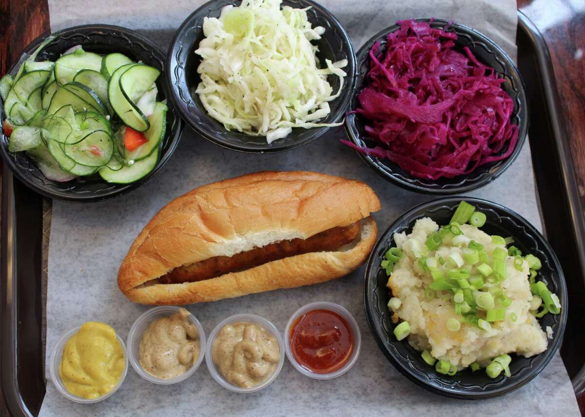 Dresden Cafe offers housemade European sausages. Clockwise from top left: German cucumber salad, sauerkraut, rotkraut, German mashed potato and Valencia sausage on a roll with curry ketchup, habanero mustard, and beer and brat mustard. The restaurant has announced that it's now closed.