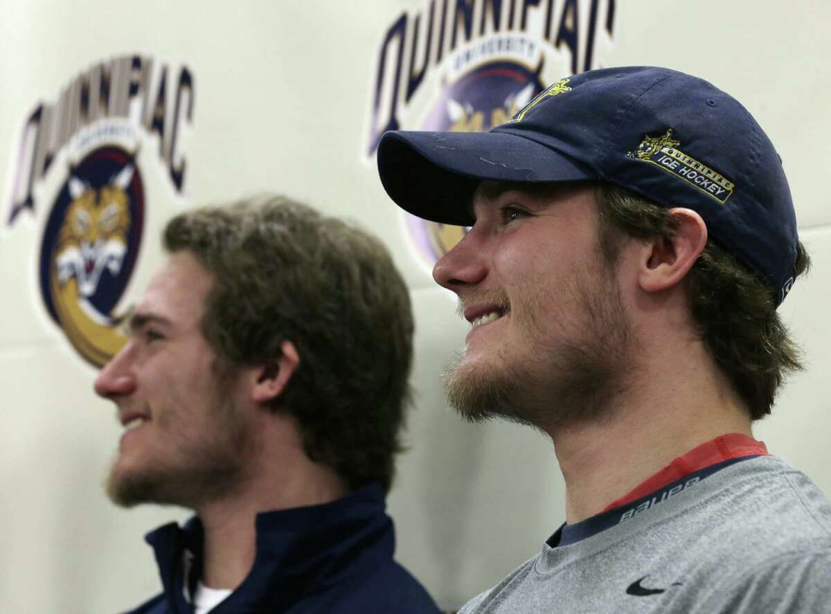 Connor Jones, right, smiles with his twin brother, Kellen, during a news conference at Quinnipiac in April 2013. The former Bobcats forwards are on tryouts with the Bridgeport Sound Tigers in training camp this week. (AP Photo/Charles Krupa)