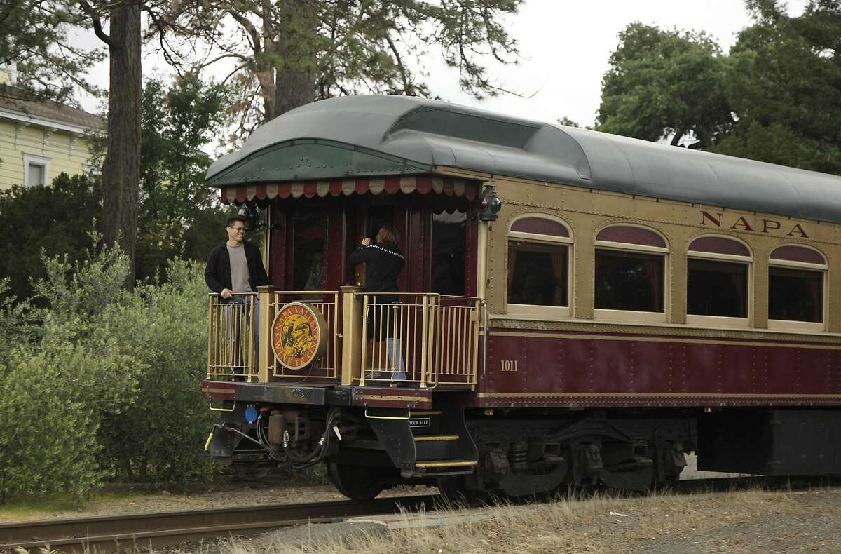 In this June 2, 2011 file photo, a couple takes pictures at the back of the Napa Valley Wine Train as it makes its way through St. Helena, Calif. Members of a mostly black book club say they believe they were kicked off the train because of their race on Saturday, Aug. 22, 2015. A race discrimination suit was to be filed on Thursday, Oct. 1, 2015.