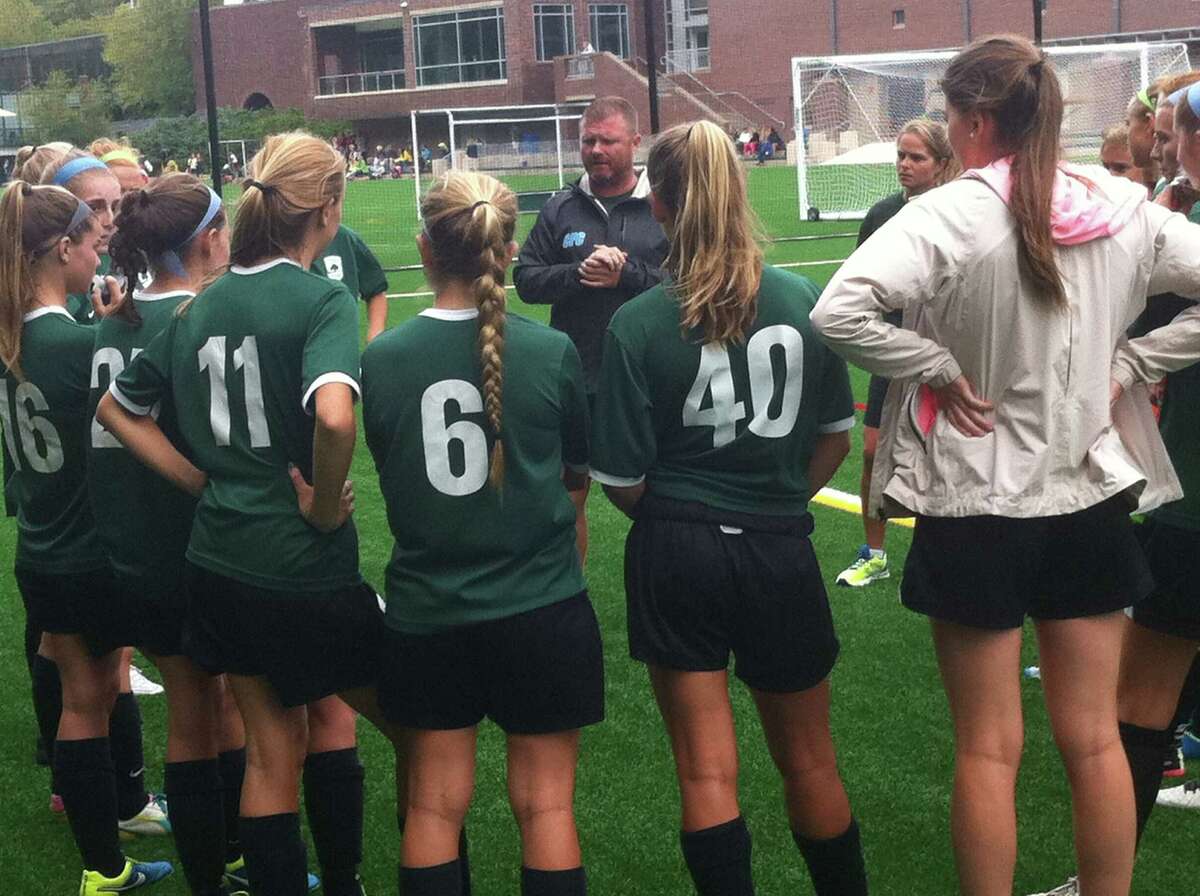Greenwich Academy soccer coach Alistair Lonsdale addresses his squad prior to Wednesday’s game against rival Convent of the Sacred Heart.