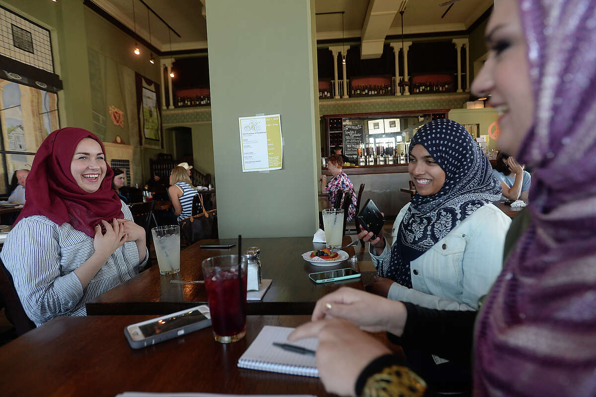Lamar University student Amber Barnhill (right) talks with Nada Hammad (left) and Oruba Shahid about their experiences as Muslim women in Southeast Texas, as well as her thoughts on an educational experiment wearing a hijab for the day. Barnhill decided to get insight into the religion and being identified as a Muslim as part of a Sociology of Religion class assignment to explore a different religion. With the okay of the community to don a hijab for the day, she went about her normal day's activities, and noted her experiences interacting with the community at large while being perceived as Muslim. She has also attended a prayer service at the Islamic Center to round out her understanding of the faith. Photo taken Wednesday, September 30, 2015 Photo by Kim Brent