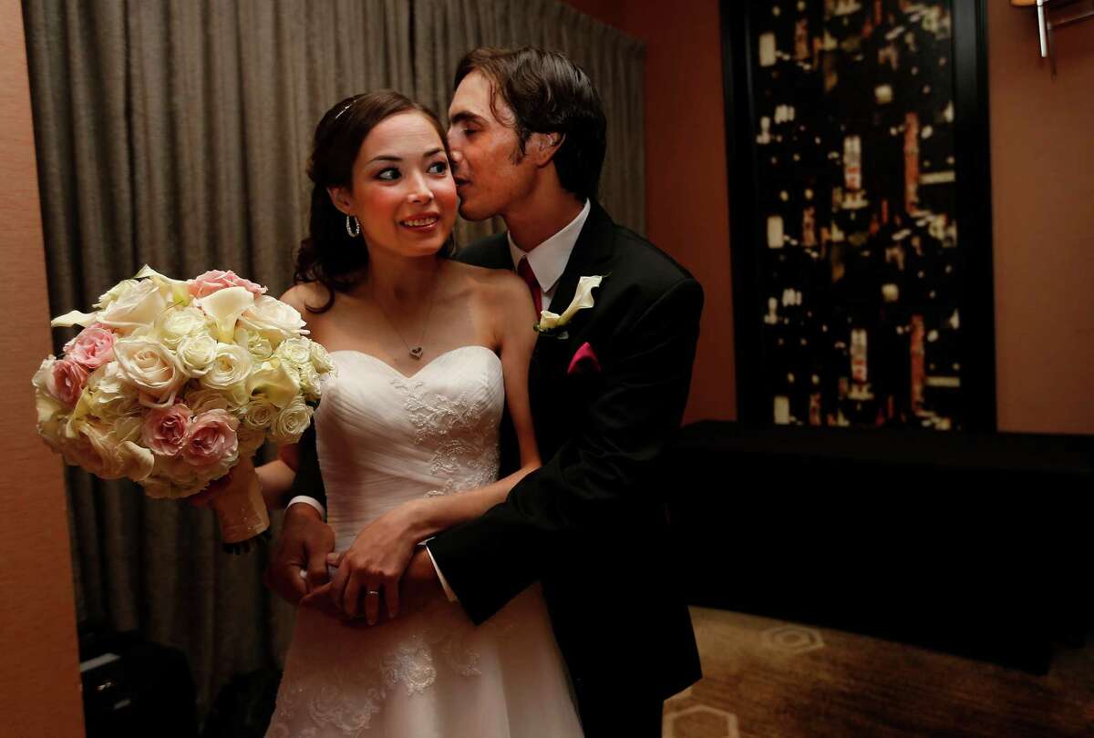 Catherine and Peter snuggle after their "Wish Upon a Wedding" wedding at Hotel Derek on Tuesday, Sept. 8, 2015. Catherine and Peter are from McAllen. Catherine suffers from cystic fibrosis and is currently awaiting a double-lung transplant that could extend her life. Wish Upon a Wedding is a non-profit that utilizes high end wedding planners and photographers to give their talents to make dreams come true for couples facing life threatening ordeals to be able to find hope. ( Karen Warren / Houston Chronicle )