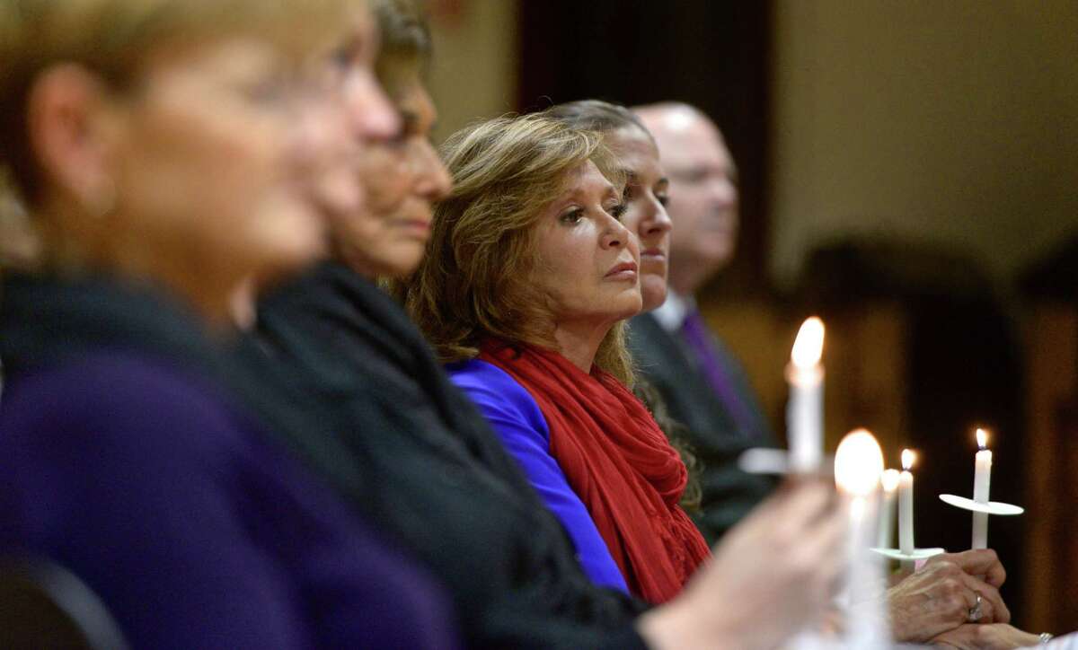 Betty Berelson, formerly of Greenwich, holds a candle and listens to the names being read from a list of those killed by domestic violence in Connecticut last year during the Greenwich YWCA Domestic Abuse Services Annual Candlelight Vigil on Thursday night, October 1, 2015, in Greenwich, Conn. October is Domestic Abuse Violence Awareness Month.