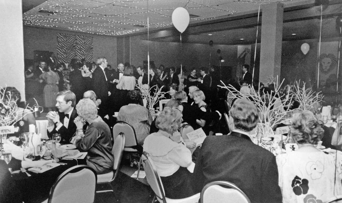 Guests dine and mingle at the annual International Ball of the YWCA of Darien-Norwalk at the Holiday Inn Crowne Plaza Hotel of Stamford, on Summer St, in March 1985. The YWCA raffled off "Nightfall in Nairobi," a 16-day photographic and wildlife safari in Kenya.