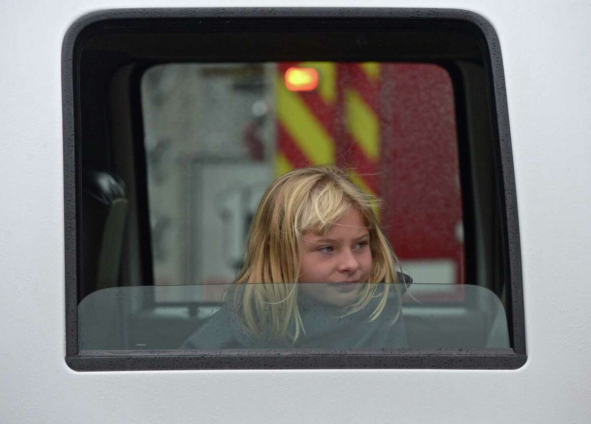 Taylor Rongetti, 9, of Danbury, watches a demonstration from the inside of a fire truck during Home Depot Fire Safety Day, at the Danbury store. Rongetti's father Chief Anthony Rongetti was taking part in a demonstration. Saturday, October 3, 2015, in Danbury, Conn.