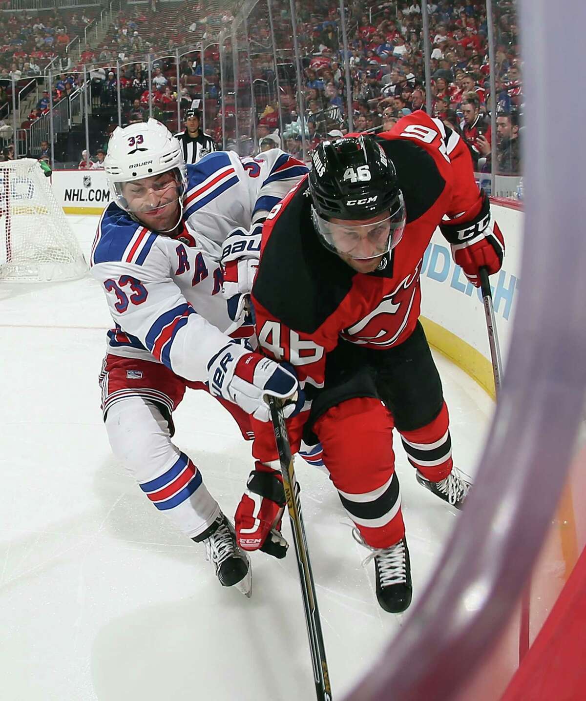 NEWARK, NJ - SEPTEMBER 26: Raphael Diaz #33 of the New York Rangers checks Mike Sislo #46 of the New Jersey Devils during the third period during a preseason game at the Prudential Center on September 26, 2015 in Newark, New Jersey. The Rangers defeated the Devils 4-3. (Photo by Bruce Bennett/Getty Images) ORG XMIT: 573904109
