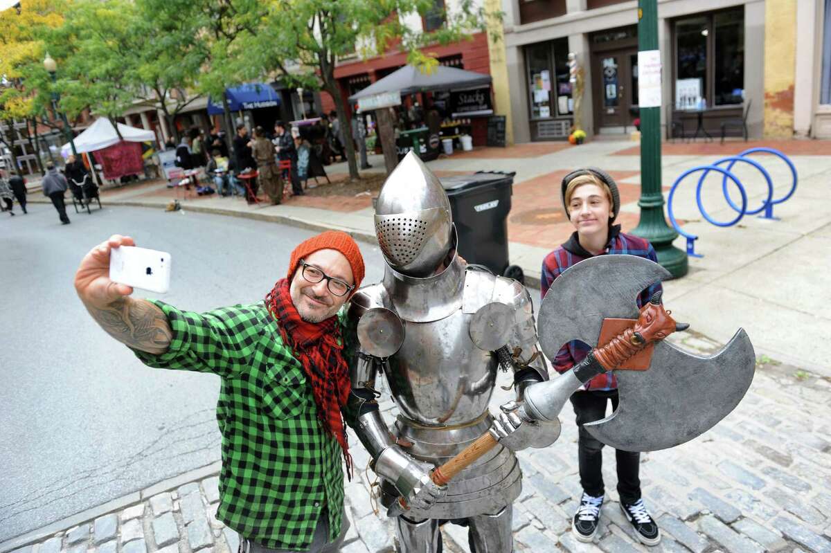 Jude Goldman of Saratoga Springs, left, and his son Mayfield Goldman, right, pose for a selfie with a knight in shining armor during the Enchanted City steampunk street festival on Saturday, Oct. 3, 2015, in Troy, N.Y. James Gillaspie of Albany was inside the protective suit that he made. The family-friendly event offered music, games, performance, food and fantasy. (Cindy Schultz / Times Union)
