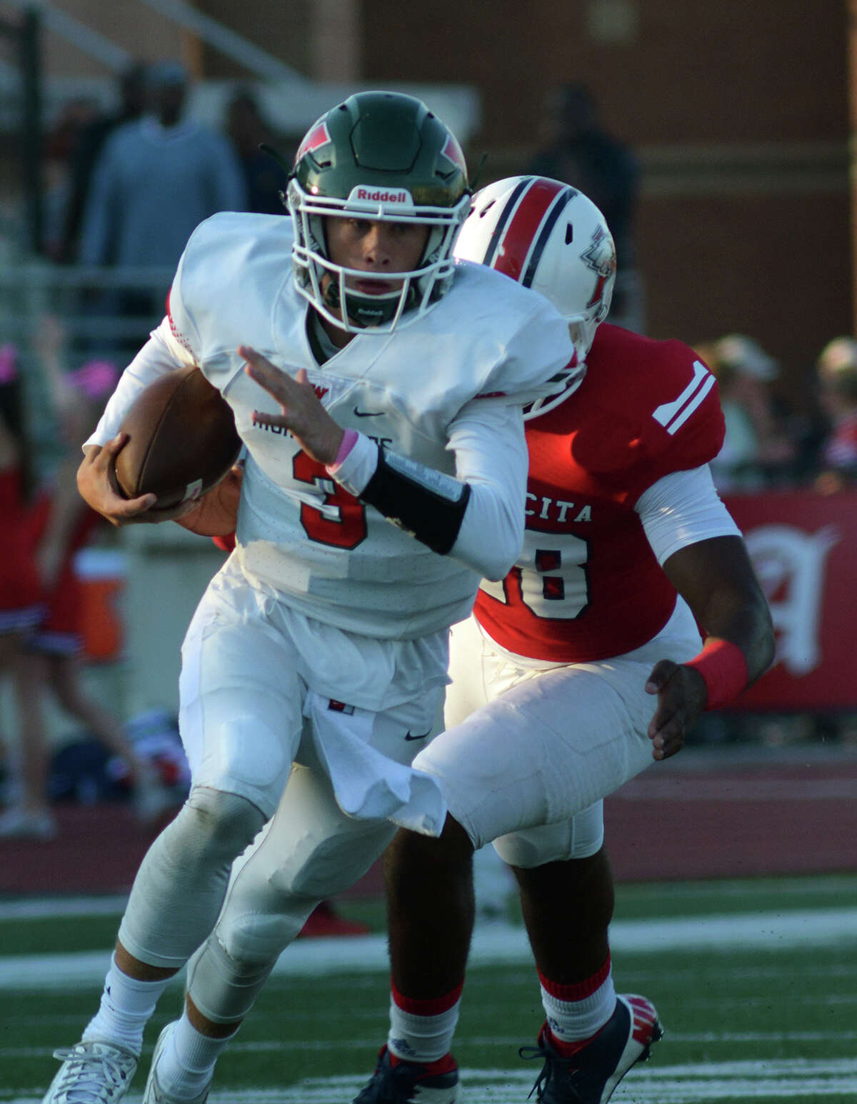 The Woodlands junior quarterback Eric Schmid (3) outruns Atascocita senior linebacker Andre Mickles Jr. during 1st quarter action of their District 16-6A matchup at Turner Stadium in Humble on Saturday, Oct. 3, 2015. (Photo by Jerry Baker/Freelance)