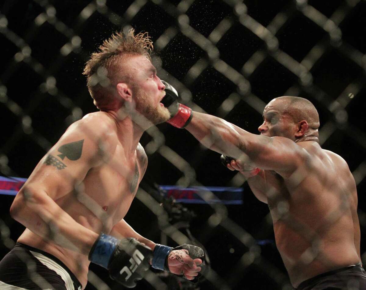 Daniel Cormier stuns Alexander Gustafsson with a hard left to the face en route to retaining his light heavyweight title by decision at UFC 192 on Saturday night.