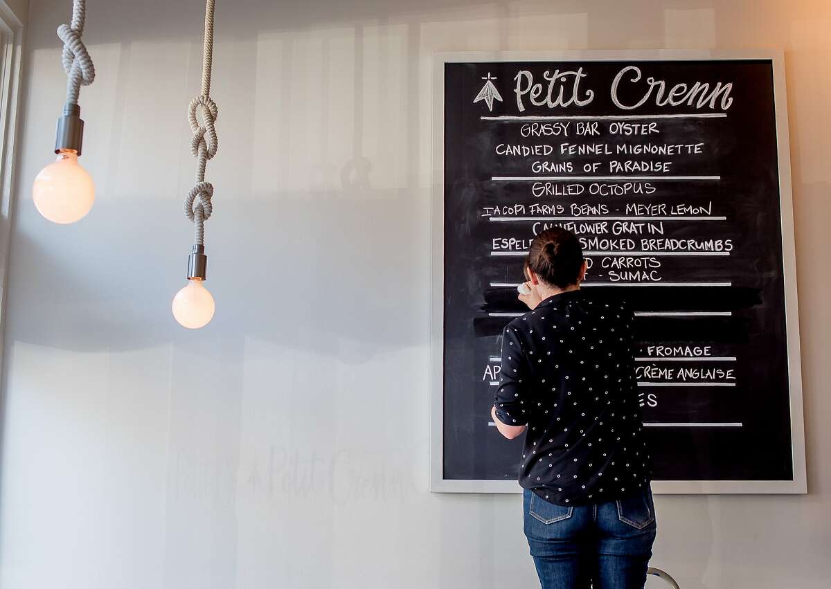 Marries Chevriere cleans the menu board at Petit Crenn in San Francisco, Calif. on Saturday, October 3rd, 2015.