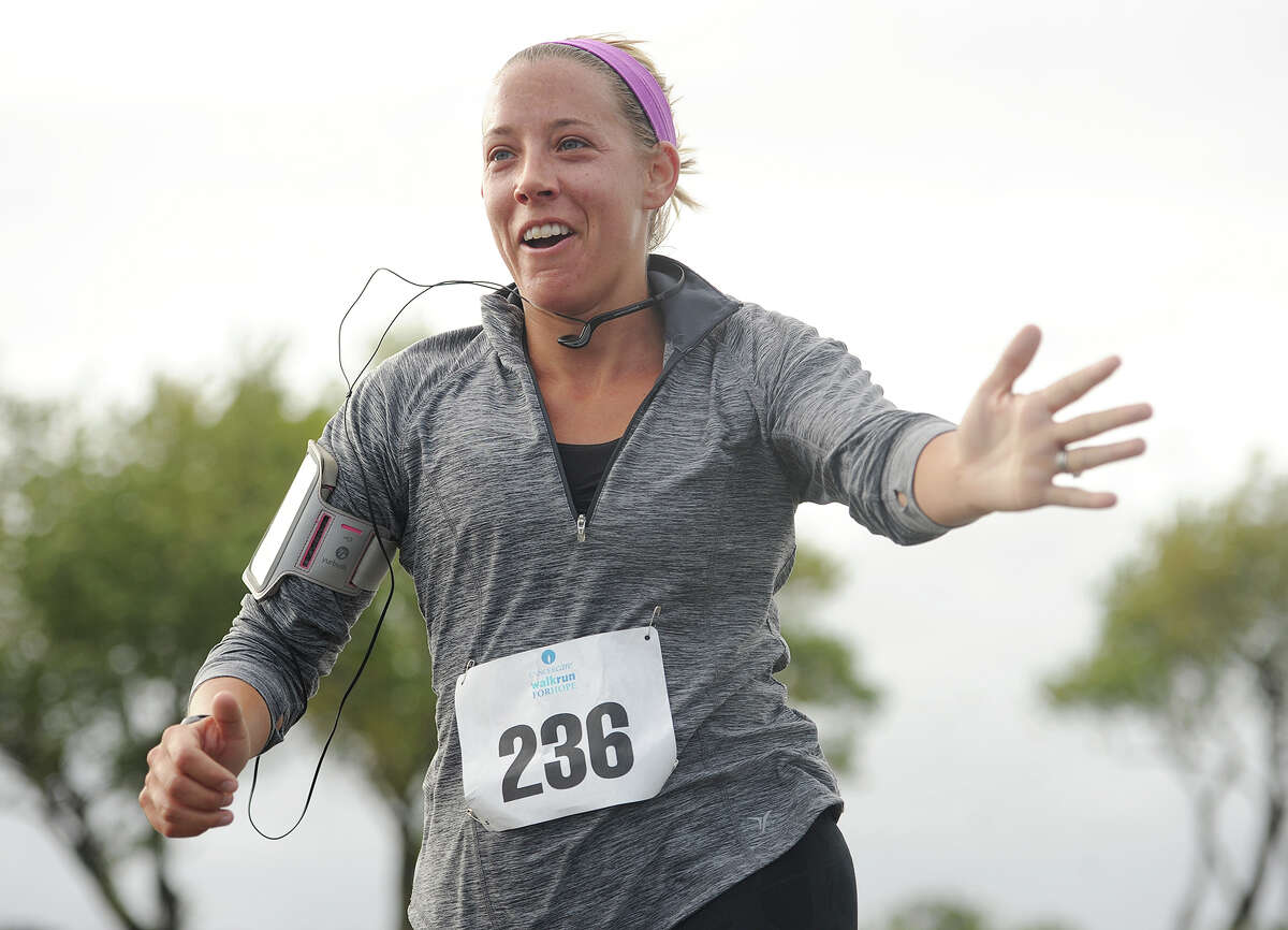 Caitlin Olson, of Fairfield, reaches out to high five her kids as she finishes the 5k 9th Annual CancerCare Fairfield Walk/Run for Hope at Jennings Beach in Fairfield, Conn. on Sunday, October 4, 2015. The event brings together family and friends in support of individuals with cancer.