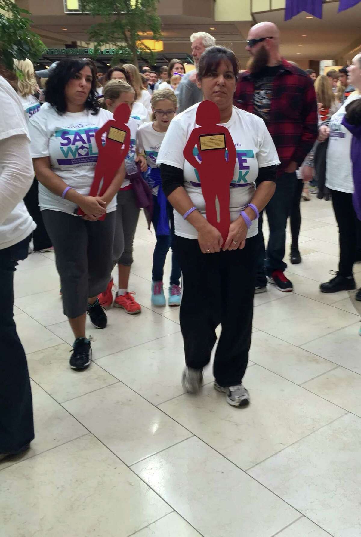 Participants in Sunday’s Safe Walk carry “silent witnesses,” which represent victims of interpersonal violence in the area since the passage of Connecticut’s domestic violence law in 1986. Nearly 1,000 people attended the Safe Walk at the Danbury Fair Mall.