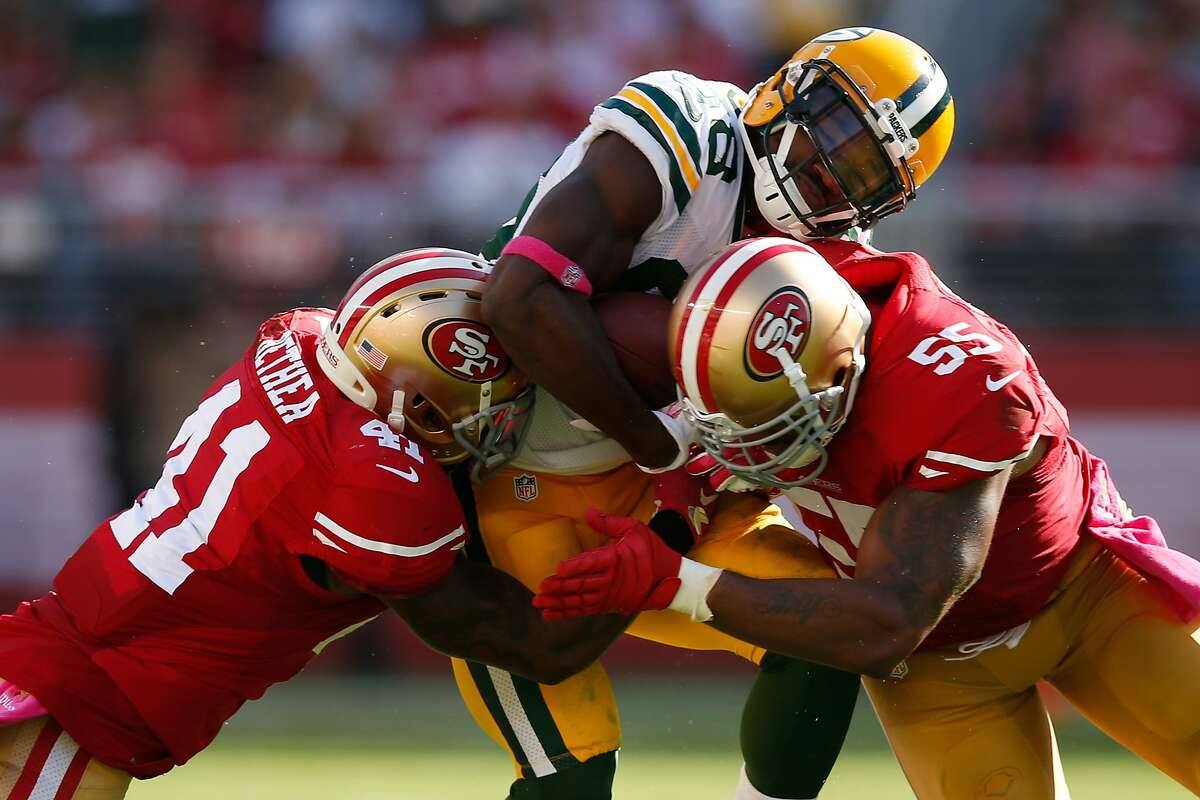 Wide receiver Ty Montgomery #88 of the Green Bay Packers is hit by strong safety Antoine Bethea #41 and outside linebacker Ahmad Brooks #55 of the San Francisco 49ers during their NFL game at Levi's Stadium on October 4, 2015 in Santa Clara, California.