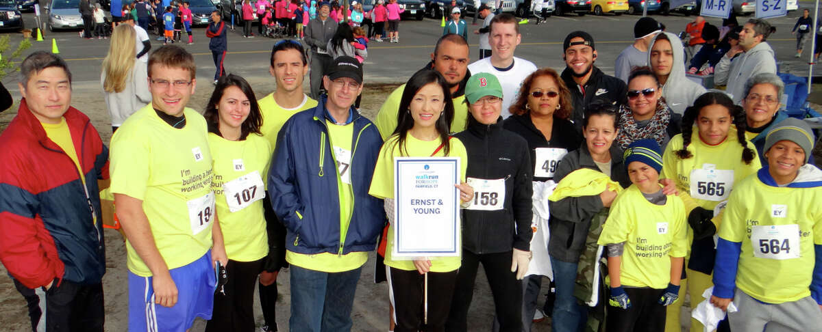 Karen Wang, center with sign, and her team of fellow employees from Ernst & Young of Stamford ready to join CancerCare's Walk/Run for Hope at Jennings Beach.