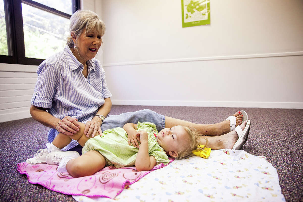 (Center) Nancy Turner, sings to her granddaughter Juliet Rocha, 1, during the final lullaby in their Music Together class Thursday Oct. 1, 2015 in the Children's Church classroom at Northwood Presbyterian Church. The program is designed to give parents and small children an opportunity to connect by making music together.