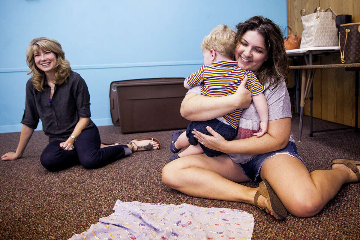 Bryce Bennett, 2, hugs his mom, Amanda, at the end of their Music Together class, a national program, Thursday Oct. 1, 2015 in the Children's Church classroom at Northwood Presbyterian Church. The program is designed to give parents and small children an opportunity to connect by making music together.
