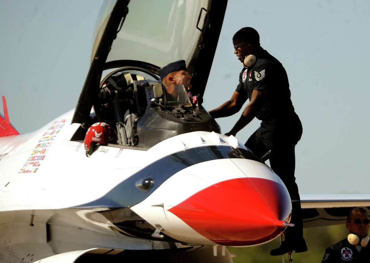 Air Force Thunderbird No. 7 Lt. Col. Derek Routt is greeted by Tech Sgt. DeCarlos Harris after a practice flight over the Lackland Air Force Base area in preparation for the weekend's AirFest 2010 on Thursday, Nov. 4, 2010. BILLY CALZADA / gcalzada@express-news.net
