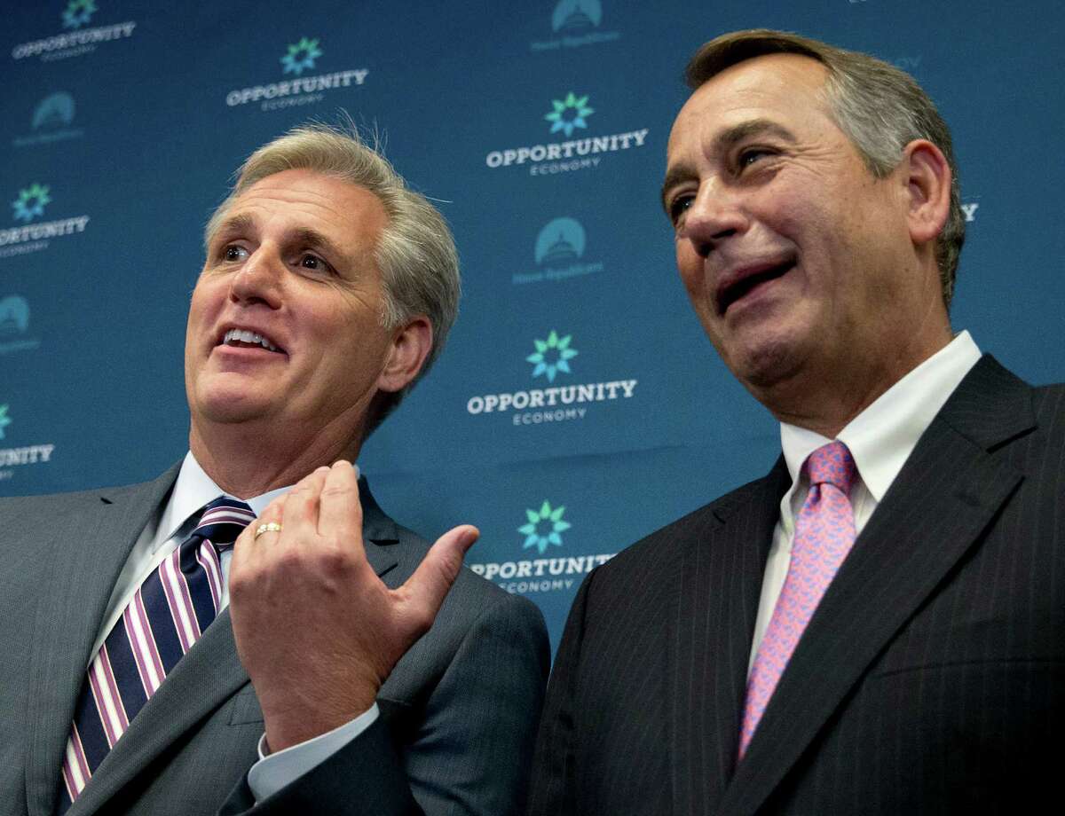 House Majority Leader Kevin McCarthy of Calif. gestures toward outgoing House Speaker John Boehner of Ohio during a new conference on Capitol Hill last week. McCarthy is assuring Republicans he can bring them together, even as emboldened conservatives maneuver to yank their party to the right in the wake of Boehner's sudden resignation.