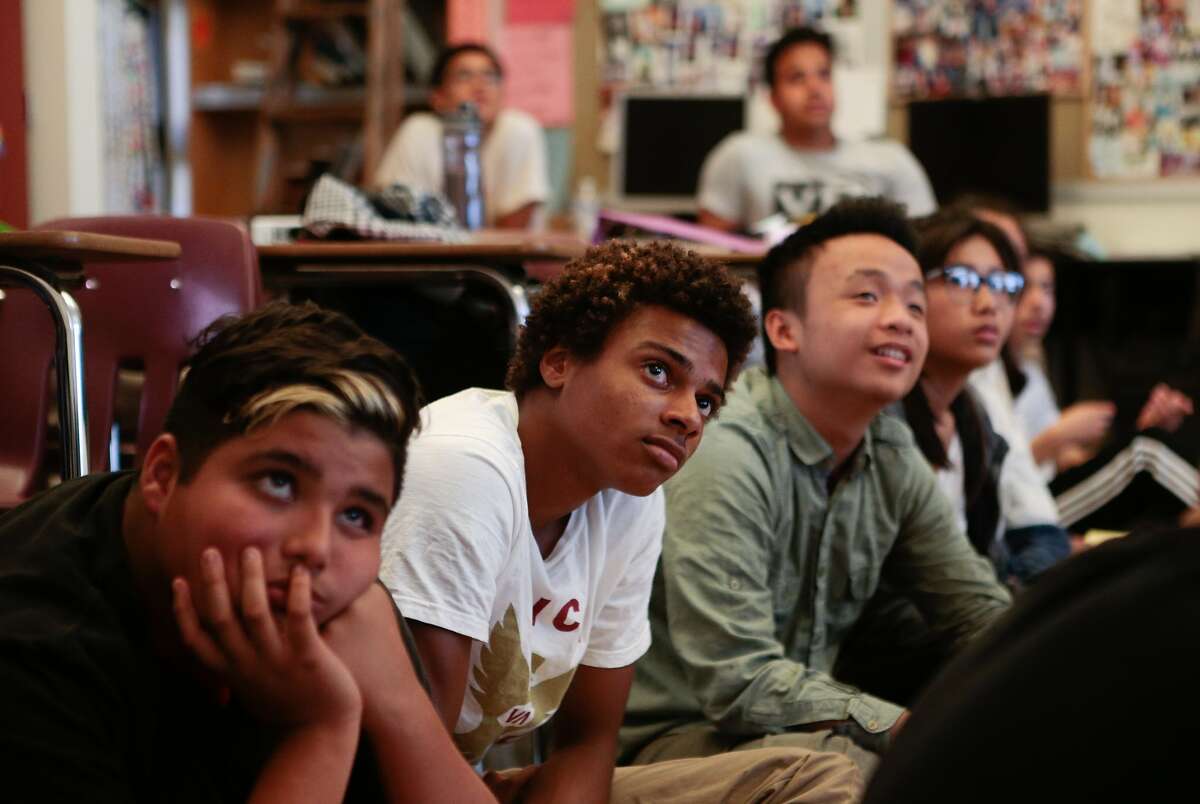 From left, Alejandro Atilano Cornejo, Chris Saniere and Austin Wong from Ali Mayer's 9-12 grade Health Education class at Abraham Lincoln High School watch a video about Hands Only CPR on Monday, Oct. 5, 2015 in San Francisco, Calif.